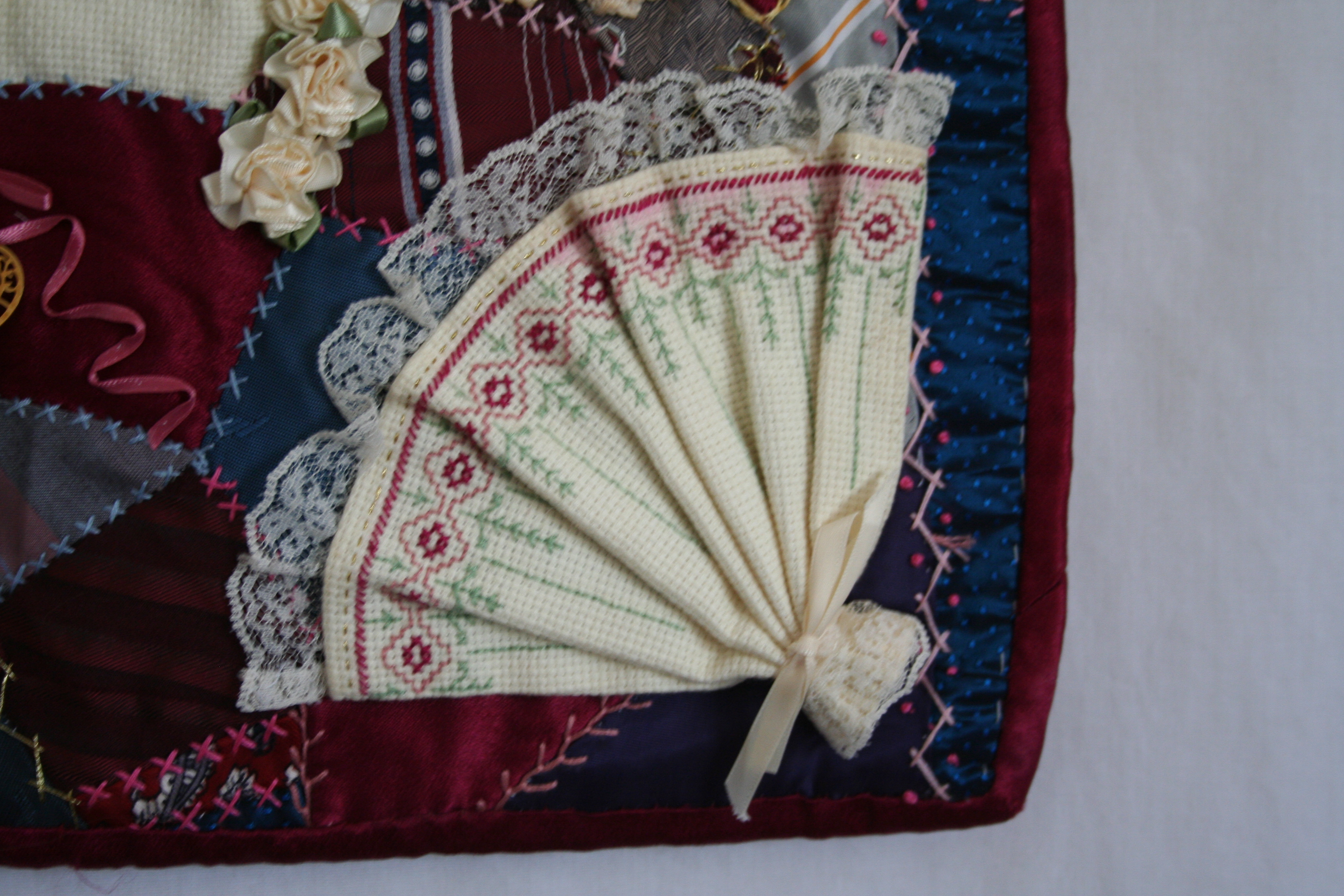 Close up of counted cross-stitch fan.
